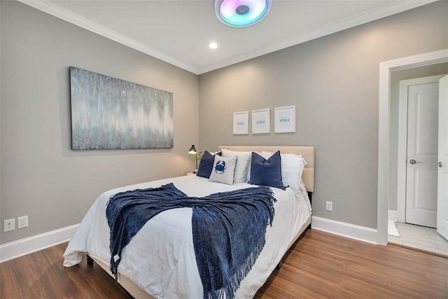 bedroom with baseboards, ornamental molding, wood finished floors, and recessed lighting