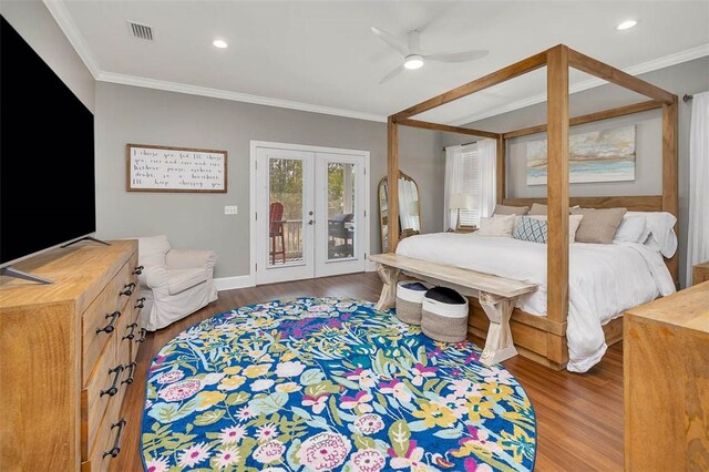bedroom featuring visible vents, ornamental molding, access to outside, wood finished floors, and french doors