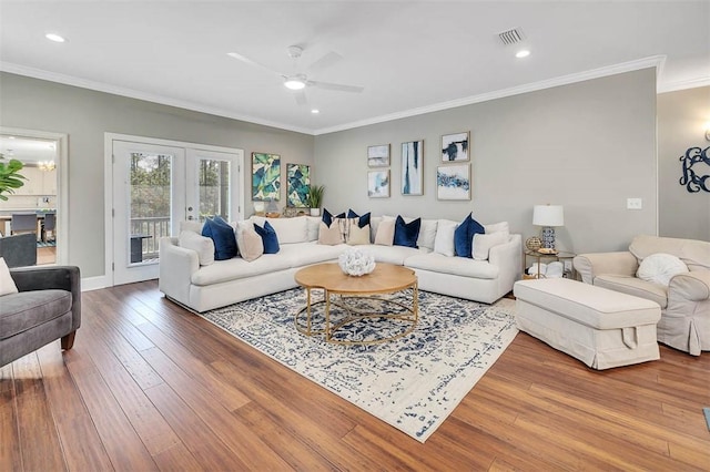 living room featuring french doors, a ceiling fan, visible vents, ornamental molding, and hardwood / wood-style floors