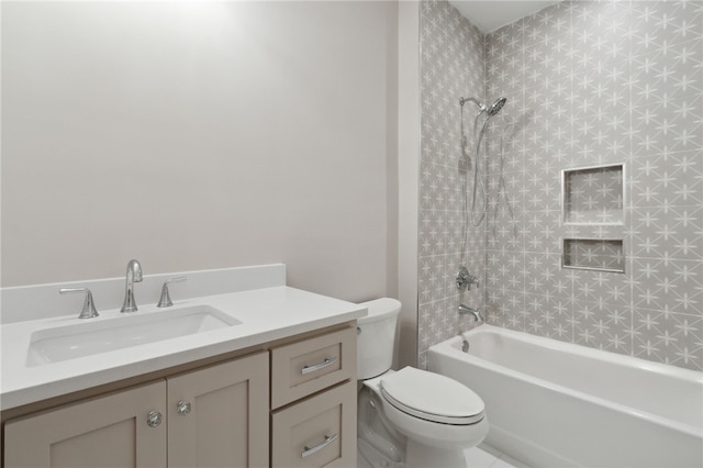 full bathroom featuring vanity, toilet, and tiled shower / bath