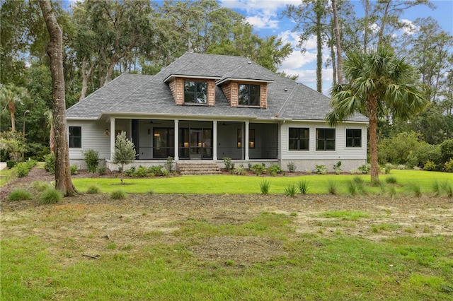 view of front of home with a front lawn and a sunroom