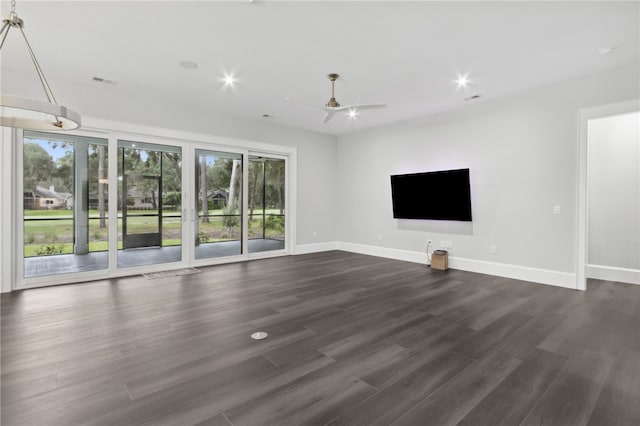 unfurnished living room featuring dark hardwood / wood-style floors, a wealth of natural light, and ceiling fan