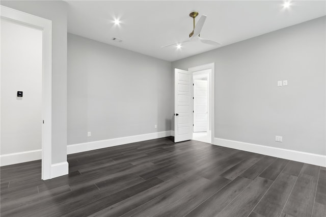 empty room with ceiling fan and dark wood-type flooring