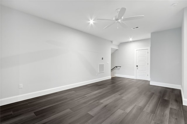 unfurnished living room with ceiling fan and dark wood-type flooring