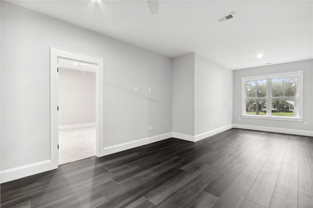 empty room with dark hardwood / wood-style flooring