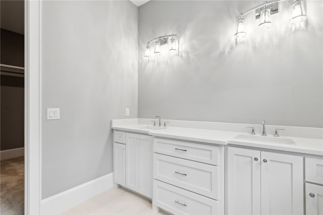 bathroom with tile patterned floors and vanity