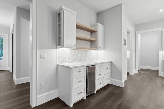 kitchen featuring white cabinets, decorative backsplash, dark hardwood / wood-style flooring, and wine cooler