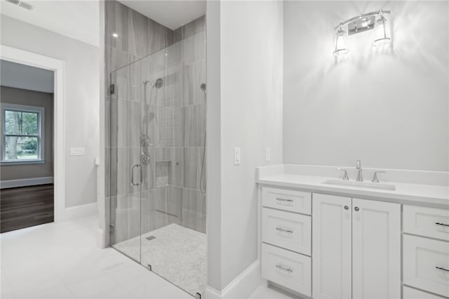 bathroom featuring vanity and a shower with shower door