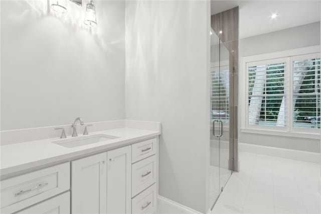 bathroom with tile patterned flooring, vanity, and a shower with shower door