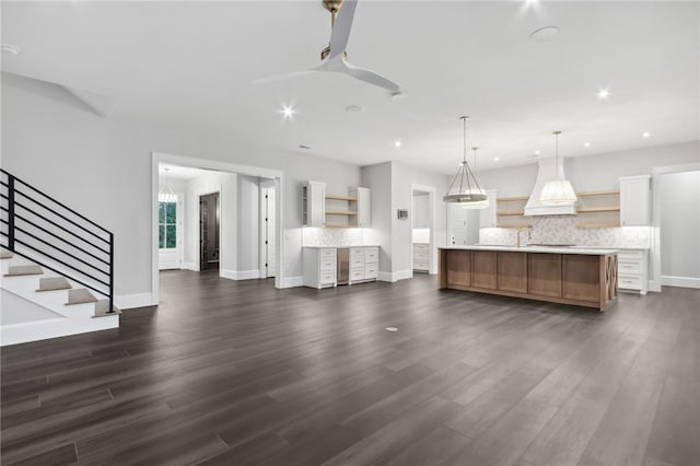 interior space featuring ceiling fan, sink, and dark wood-type flooring