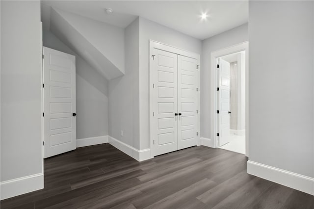 bonus room with dark hardwood / wood-style flooring