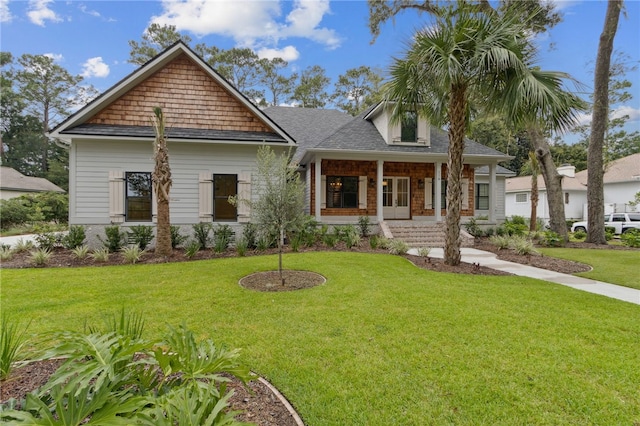 craftsman-style house featuring covered porch and a front yard