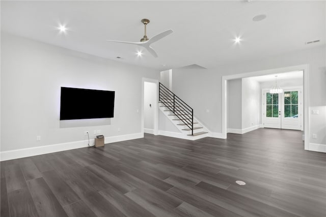 unfurnished living room featuring dark hardwood / wood-style floors, ceiling fan, and french doors