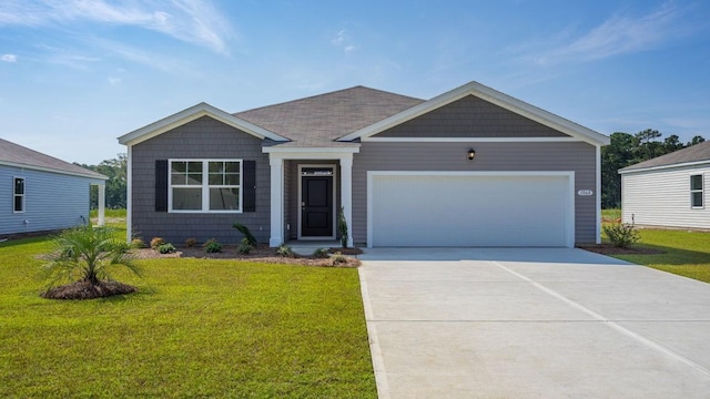 view of front facade with a garage and a front lawn