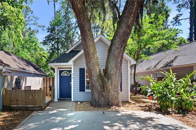 bungalow-style home with fence
