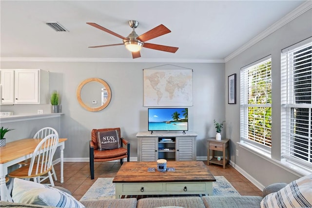 living room featuring baseboards, tile patterned flooring, and crown molding