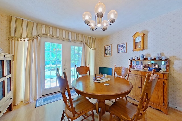 540 Jenkins St, Blackshear, GA 31516 - dining space with wallpapered walls, light wood-style floors, healthy amount of natural light, a chandelier, and french doors