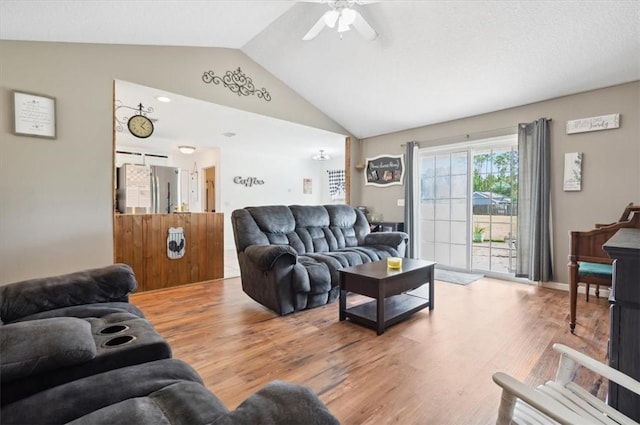 living room featuring hardwood / wood-style floors, vaulted ceiling, and ceiling fan