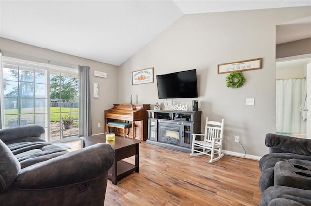 living room featuring hardwood / wood-style floors and vaulted ceiling