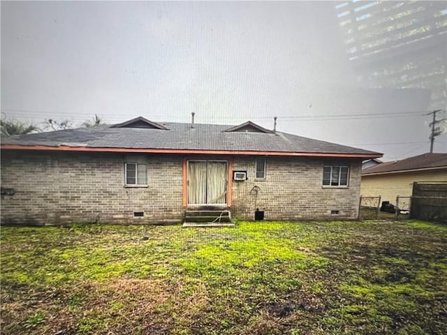 rear view of property with a yard