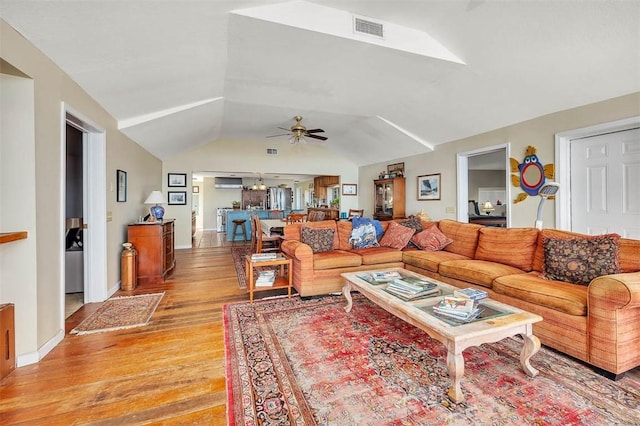 living room with lofted ceiling, light hardwood / wood-style flooring, and ceiling fan