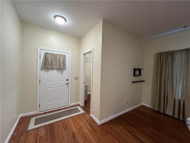 entryway featuring baseboards and wood finished floors