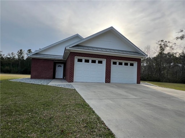 ranch-style house featuring driveway, a standing seam roof, an attached garage, a front lawn, and brick siding