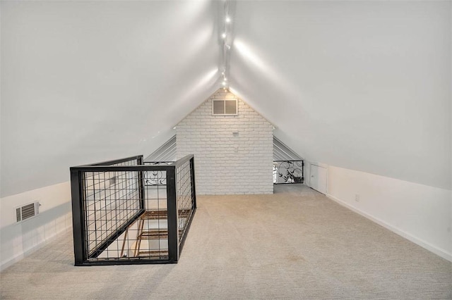 bonus room featuring carpet, lofted ceiling, visible vents, brick wall, and baseboards