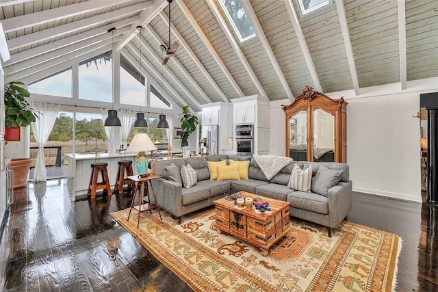 living room with high vaulted ceiling, a skylight, dark wood finished floors, and beamed ceiling