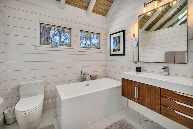 bathroom featuring vaulted ceiling with beams, wooden ceiling, toilet, a freestanding bath, and marble finish floor