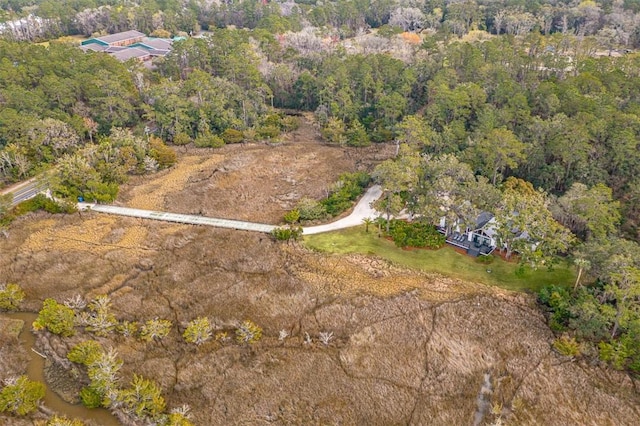 birds eye view of property featuring a wooded view