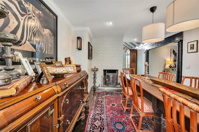 dining space featuring a brick fireplace and ornamental molding