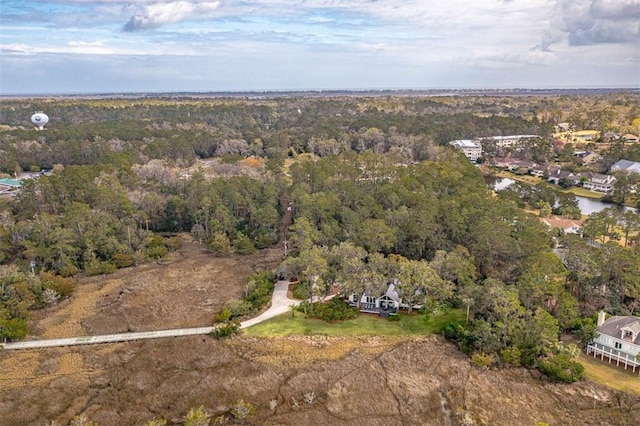 birds eye view of property with a forest view