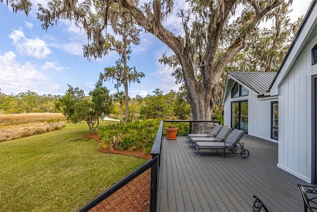 wooden deck featuring a yard