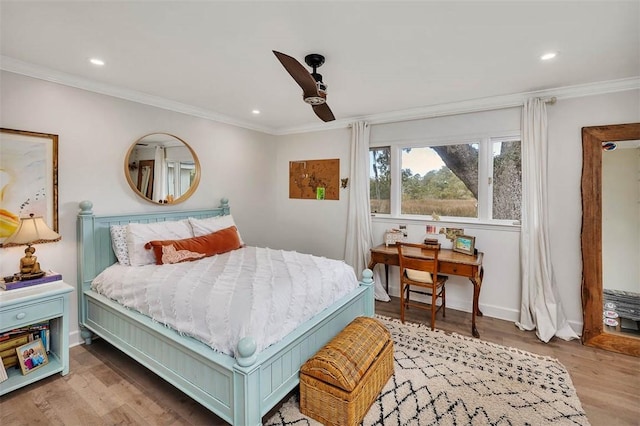 bedroom with baseboards, ceiling fan, ornamental molding, wood finished floors, and recessed lighting