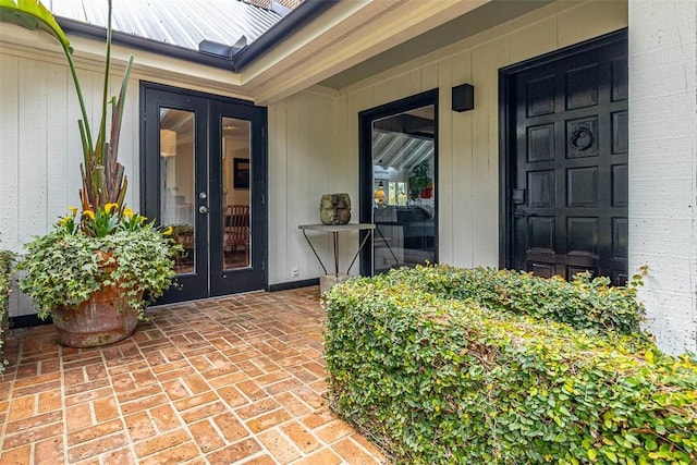 entrance to property featuring french doors and metal roof