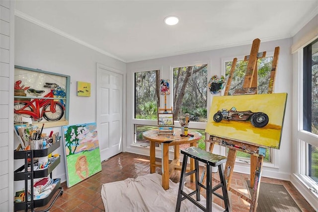 interior space featuring brick floor, plenty of natural light, and ornamental molding