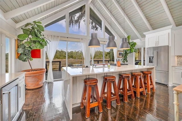 kitchen with dark wood-style floors, light countertops, high quality fridge, and wine cooler