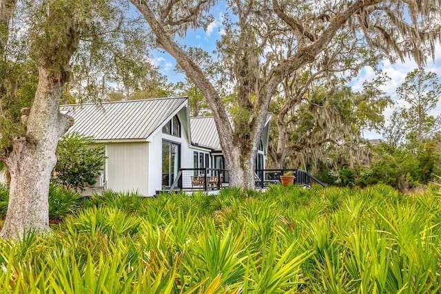 view of property exterior featuring metal roof and a standing seam roof