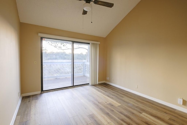 spare room with a ceiling fan, wood finished floors, lofted ceiling, and baseboards