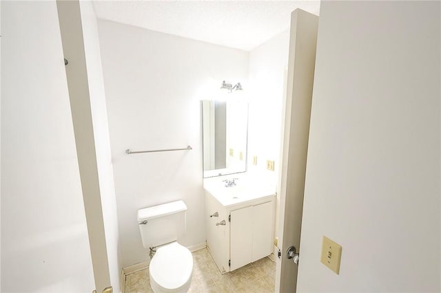 bathroom with tile patterned floors, vanity, and toilet