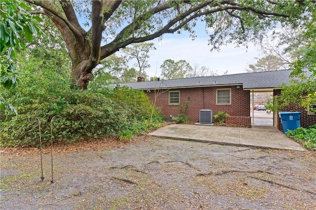 rear view of property featuring central AC and a patio