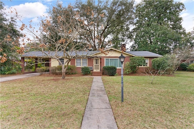 ranch-style home featuring a carport and a front yard