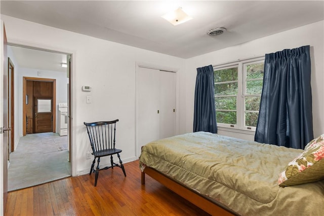 bedroom with hardwood / wood-style flooring and a closet