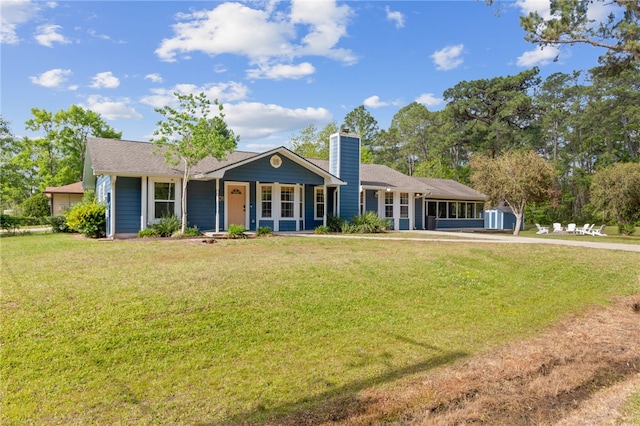 501 W Hall St, Saint Marys, GA 31558 - view of front of house featuring an outbuilding, a front yard, a storage unit, and a chimney