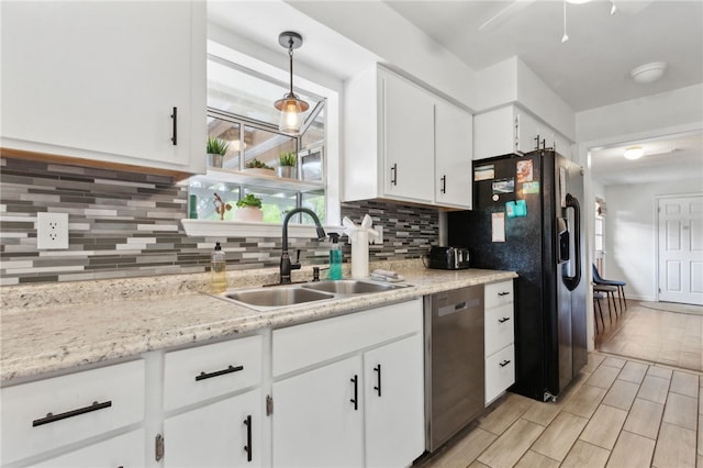 501 W Hall St, Saint Marys, GA 31558 - kitchen featuring stainless steel dishwasher, white cabinets, a sink, black refrigerator with ice dispenser, and backsplash