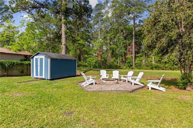 501 W Hall St, Saint Marys, GA 31558 - view of yard featuring an outbuilding, fence, a storage unit, and an outdoor fire pit