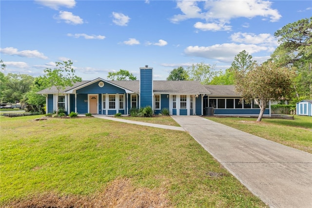 501 W Hall St, Saint Marys, GA 31558 - ranch-style home with a chimney, a front yard, driveway, and a sunroom