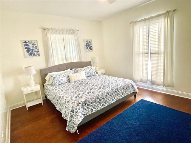 bedroom featuring baseboards and wood finished floors