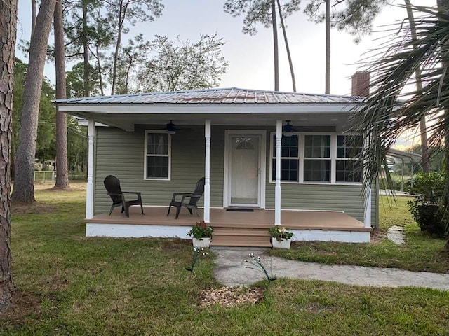 view of front of house with a front yard and a porch